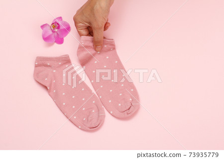Pair of women socks on pink background. Pair of women socks on pink background. 73935779
