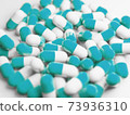 A large number of blue capsules (medicines, supplements) stock photos 73936310