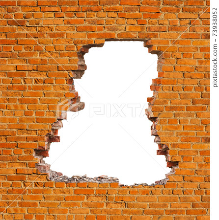 Broken hole in an old brick wall 73938052