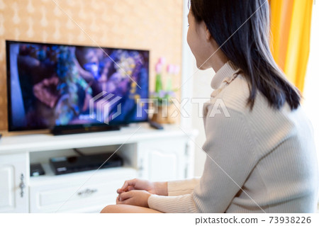 Happy asian child girl watch cartoon movie on TV,activity for her after from school in living room at home,cause of nearsighted and hyperactivity disorder comes from watching television on daily basis Happy asian child girl watch cartoon movie on TV,activity for her after from school in living room at home,cause of nearsighted and hyperactivity disorder comes from watching television on daily basis 73938226