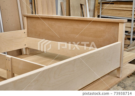 Joinery. Bed building process. Wooden furniture manufacturing process. Furniture manufacture. Close-up Joinery. Bed building process. Wooden furniture manufacturing process. Furniture manufacture. Close-up 73938714