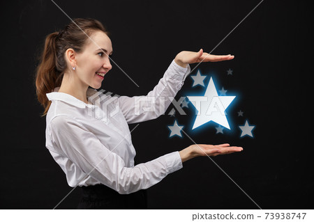 Girl abstractly holds stars as a concept rating. Girl abstractly holds stars as a concept rating. 73938747