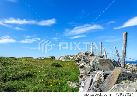Stone wall and fence at the coastline at Dawros in County Donegal - Ireland 73938824