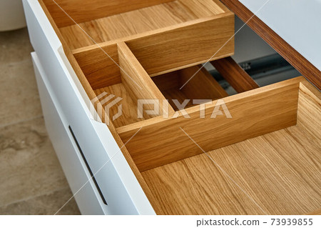 Opened wooden drawer of bathroom vanity in luxury bathroom. Stylish interior of modern bathroom. Details furniture 73939855