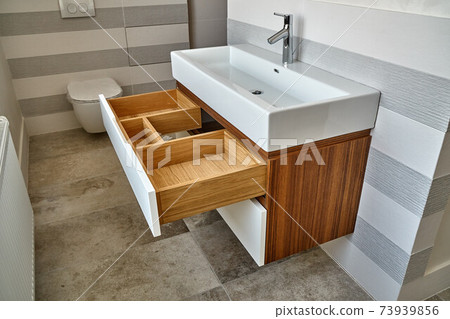 Wall mounted bathroom vanity in luxury bathroom. Stylish interior of modern bathroom. Details furniture Wall mounted bathroom vanity in luxury bathroom. Stylish interior of modern bathroom. Details furniture 73939856