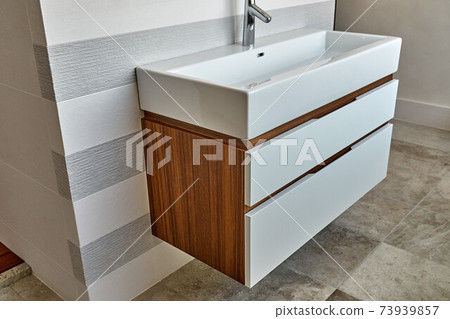 Wall mounted bathroom vanity in luxury bathroom. Stylish interior of modern bathroom. Details furniture 73939857