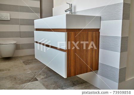 Wall mounted bathroom vanity in luxury bathroom. Stylish interior of modern bathroom. Details furniture Wall mounted bathroom vanity in luxury bathroom. Stylish interior of modern bathroom. Details furniture 73939858