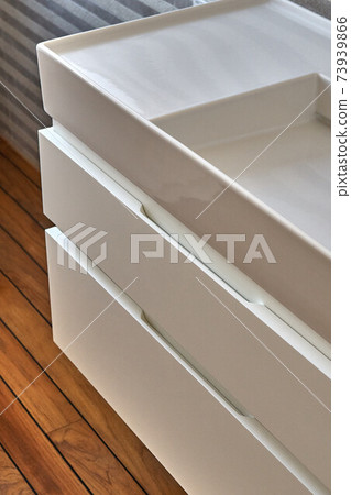 Wall mounted bathroom vanity in luxury bathroom with teak floor. Stylish interior of modern bathroom. Details furniture 73939866