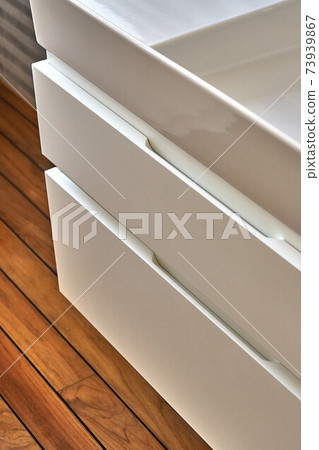 Wall mounted bathroom vanity in luxury bathroom with teak floor. Stylish interior of modern bathroom. Details furniture Wall mounted bathroom vanity in luxury bathroom with teak floor. Stylish interior of modern bathroom. Details furniture 73939867