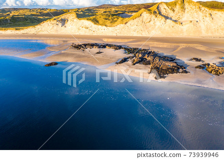The coast between Kiltoorish bay beach and the Sheskinmore bay between Ardara and Portnoo in Donegal - Ireland 73939946