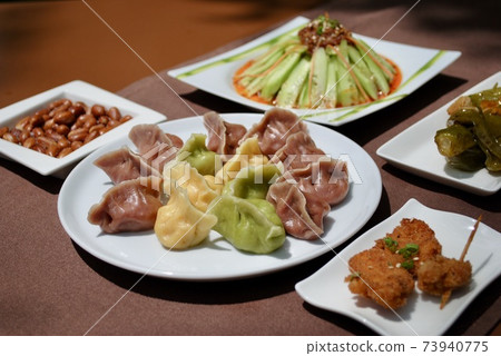 Colorful handmade dumplings with variety side dishes on table . Jiaozi. Colorful handmade dumplings with variety side dishes on table . Jiaozi. 73940775