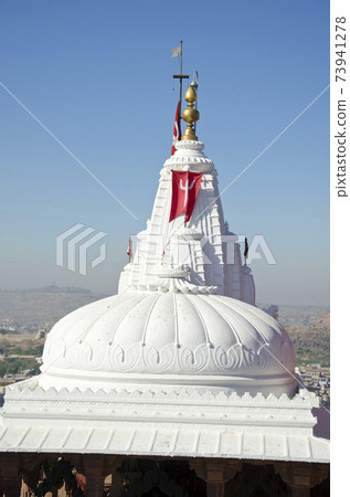 white Shiva temple dome with flag, India 73941278