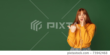 Caucasian woman's portrait isolated on green studio background with copyspace, horizontal flyer 73942468