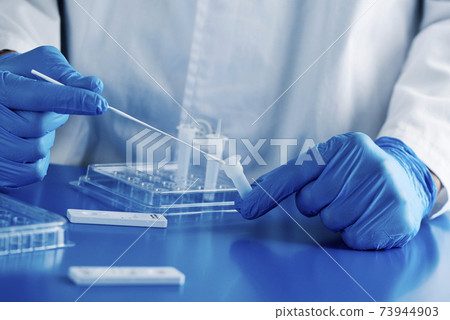 healthcare worker using a covid-19 antigen test healthcare worker using a covid-19 antigen test 73944903
