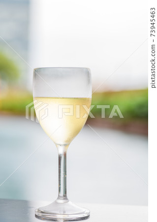 White wine in a glass White wine in a glass 73945463