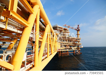 Offshore construction platform for production oil and gas. Oil and gas industry and hard work. Production platform and operation process by manual and auto function from control room. Offshore construction platform for production oil and gas. Oil and gas industry and hard work. Production platform and operation process by manual and auto function from control room. 73945501