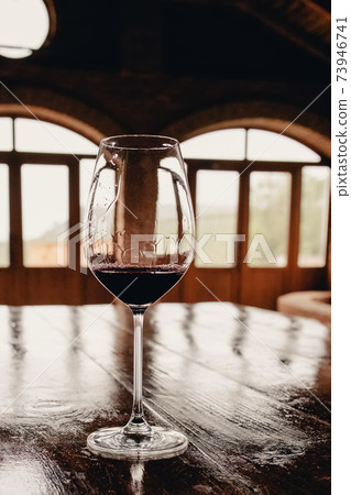 A glass of red wine on rustic wooden table A glass of red wine on rustic wooden table 73946741