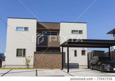 Black car and white house 73947356