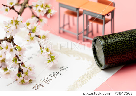 Diploma, round tube and school desk 73947565