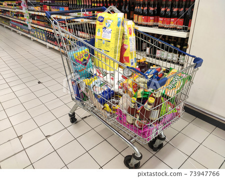 KUALA LUMPUR, MALAYSIA - MARCH 24, 2020: Groceries that have been picked up are placed in the cart before payment is made at the payment counter. Shopping carts make it easy for customers to shop. 73947766