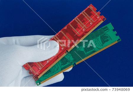 Hand in white glove holds two memory cards. Hand in white glove holds two memory cards. 73948069