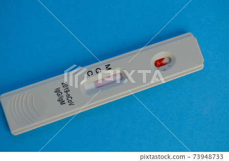 coronavirus test lies on a blue background. there is a drop of blood on the test strip. express diagnostics of coronavirus. home test to diagnose infection coronavirus test lies on a blue background. there is a drop of blood on the test strip. express diagnostics of coronavirus. home test to diagnose infection 73948733