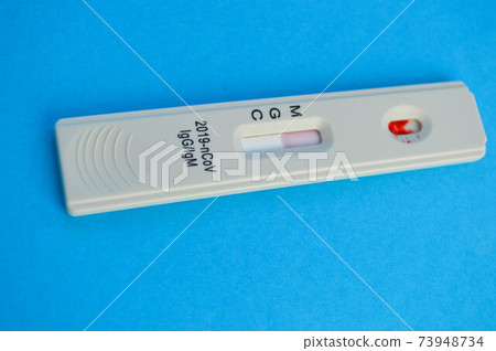 coronavirus test lies on a blue background. a drop of venous blood is dripped onto the test strip. medical laboratory, express diagnostics of coronavirus coronavirus test lies on a blue background. a drop of venous blood is dripped onto the test strip. medical laboratory, express diagnostics of coronavirus 73948734