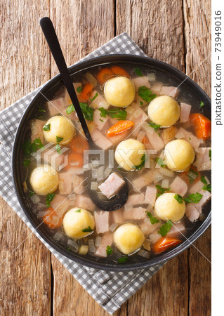 Hafalaab Traditional Liechtenstein soup with ham and cornmeal dumplings closeup in the plate on the table. vertical top view Hafalaab Traditional Liechtenstein soup with ham and cornmeal dumplings closeup in the plate on the table. vertical top view 73949016