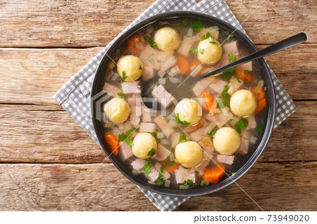 Hafalaab soup with ham, vegetables and cornmeal dumplings close-up in a plate. horizontal top view Hafalaab soup with ham, vegetables and cornmeal dumplings close-up in a plate. horizontal top view 73949020