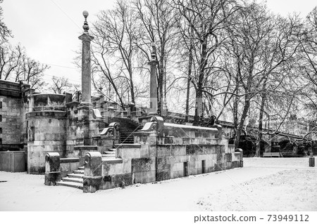 Stone brige staircase covered by snow 73949112