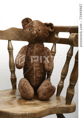 teddy bear sitting in an old vintage wooden armchair teddy bear sitting in an old vintage wooden armchair 73949987