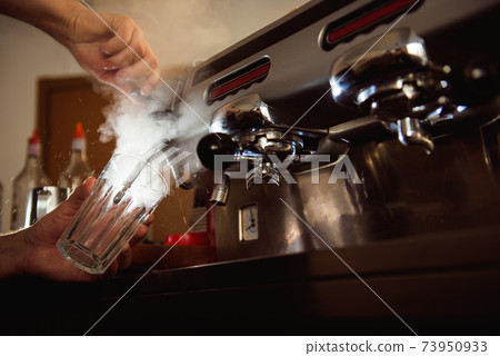 Close up barista hands making coffee cup with coffee machine in coffee shop Close up barista hands making coffee cup with coffee machine in coffee shop 73950933