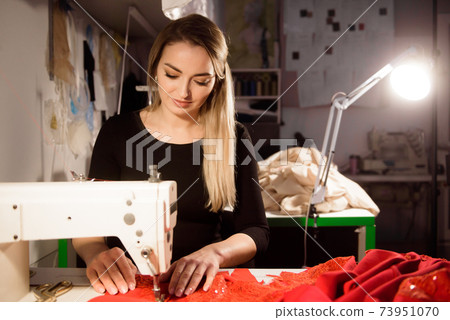 Process of sewing in atelier or workshop. Tailoring and repair of clothing, self-employed employee. 73951070