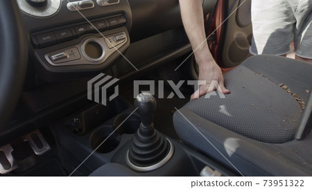 Man cleaning dirty car interior with vacuum cleaner Man cleaning dirty car interior with vacuum cleaner 73951322