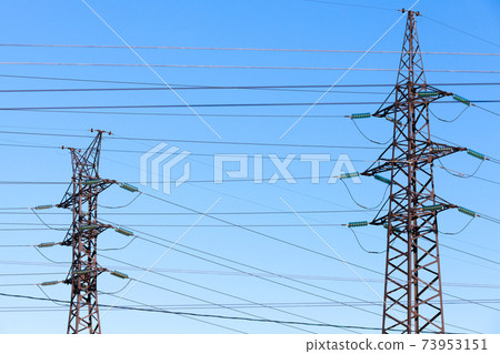 Lattice-type steel towers over blue sky Lattice-type steel towers over blue sky 73953151