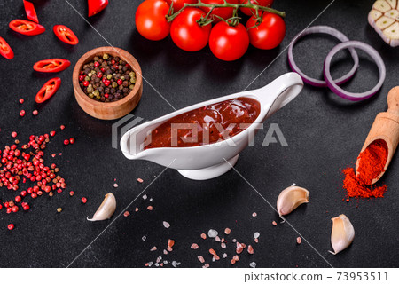 Spicy seasoning of Georgian cuisine adjika in a bowl with red pepper and garlic Spicy seasoning of Georgian cuisine adjika in a bowl with red pepper and garlic 73953511