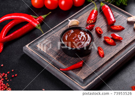 Spicy seasoning of Georgian cuisine adjika in a bowl with red pepper and garlic Spicy seasoning of Georgian cuisine adjika in a bowl with red pepper and garlic 73953526