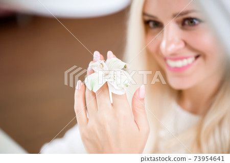 beauty delicate hands with manicure holding flower lily. beauty delicate hands with manicure holding flower lily. 73954641
