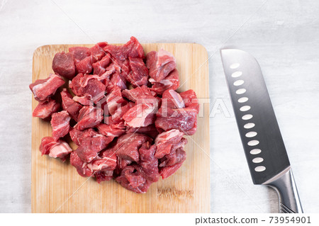 Fresh meat cut into thin pieces on wooden board Fresh meat cut into thin pieces on wooden board 73954901
