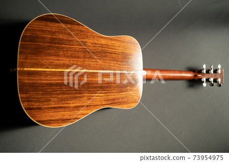 Acoustic guitar black background 73954975