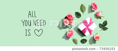 All you need is love message with a gift box and roses 73956283