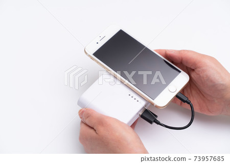 A female mobile battery that charges a smartphone A female mobile battery that charges a smartphone 73957685