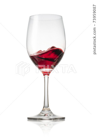 Red wine poured into a glass 73959087
