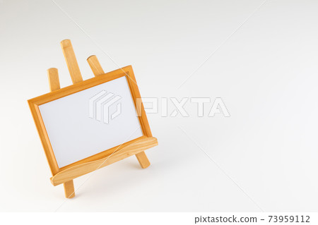 Wooden frame on an easel Wooden frame on an easel 73959112