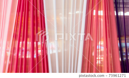 Beautiful multi-colored curtains decorated as a backdrop for the Buddhist ceremonies in Southeast Asia. Fabric colour and texture swatches. Background of colorful curtains hangs seamlessly together. Beautiful multi-colored curtains decorated as a backdrop for the Buddhist ceremonies in Southeast Asia. Fabric colour and texture swatches. Background of colorful curtains hangs seamlessly together. 73961271