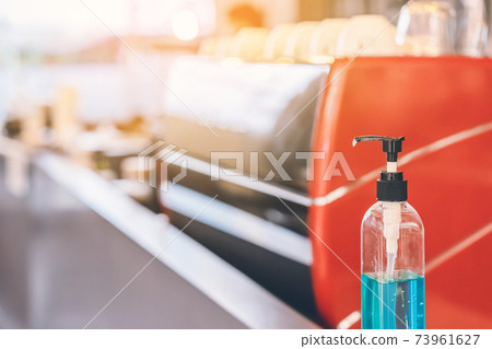 Blue alcohol gel bottle for hands cleaning to prevent the spreading of the Corona virus (Covid-19), Place the entrance service for customers in the cafe. Healthcare concept. New normal lifestyle. Blue alcohol gel bottle for hands cleaning to prevent the spreading of the Corona virus (Covid-19), Place the entrance service for customers in the cafe. Healthcare concept. New normal lifestyle. 73961627