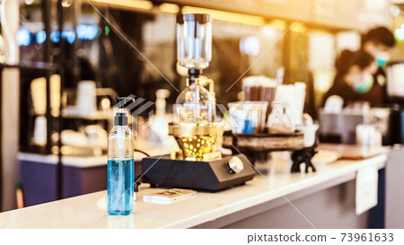 Blue alcohol gel bottle for hands cleaning to prevent the spreading of the Corona virus (Covid-19), Place the entrance service for customers in the cafe. Healthcare concept. New normal lifestyle. Blue alcohol gel bottle for hands cleaning to prevent the spreading of the Corona virus (Covid-19), Place the entrance service for customers in the cafe. Healthcare concept. New normal lifestyle. 73961633