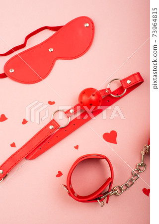 BDSM set in red on a pink background. Love symbol for valentine's day. 73964815