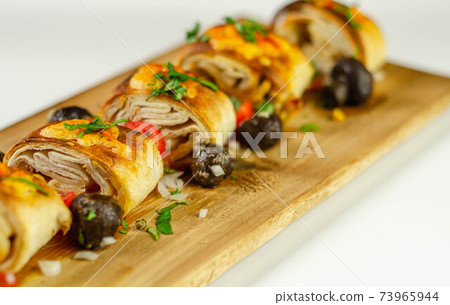 Baked pieces of tortilla wrap with chicken breast and Grana Padano cheese on the wood Baked pieces of tortilla wrap with chicken breast and Grana Padano cheese on the wood 73965944