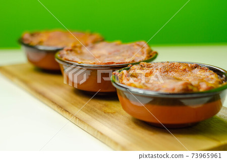 Traditional french onion gratin soup served in a ceramic bowl on a wood 73965961